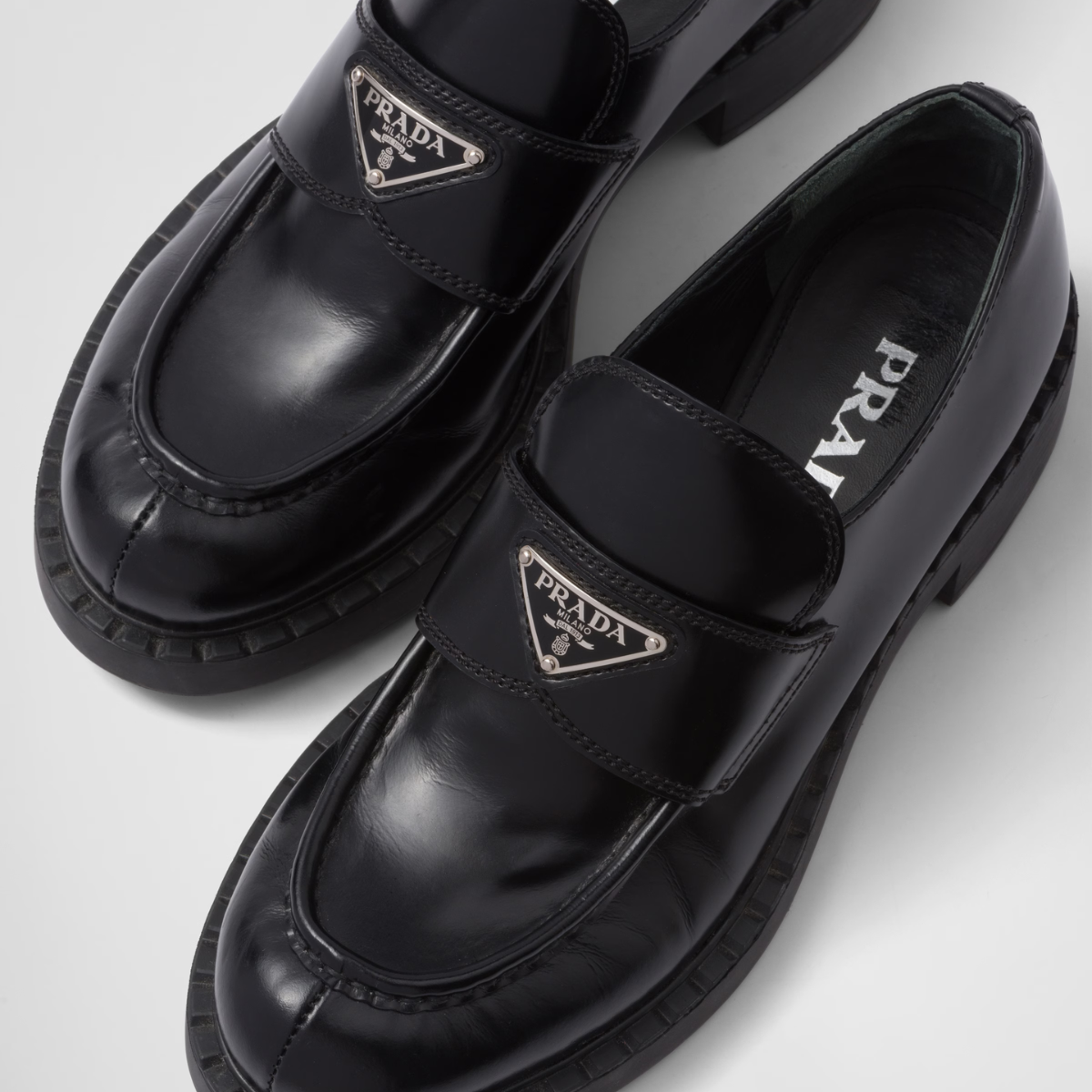 Chocolate brushed leather loafers – upper with leather strap Enameled metal triangle logo 50 mm rubber monobloc sole – LUX VERSE Luxury Designer Fashion Outlet