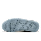 Kaws – serving as the collection's sole footwear offering, the Air Jordan 4 Retro is given – LUX VERSE Luxury Designer Fashion Outlet