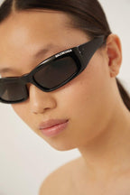 Black rectangular sunglasses – a concept featuring really smooth surfaces, volumes and peculiar bended end pieces – LUX VERSE Luxury Designer Fashion Outlet
