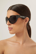 Black wrap around sunglasses – lenses are set atop curved, bio injected frames, as opposed to inside or behind them – LUX VERSE Luxury Designer Fashion Outlet