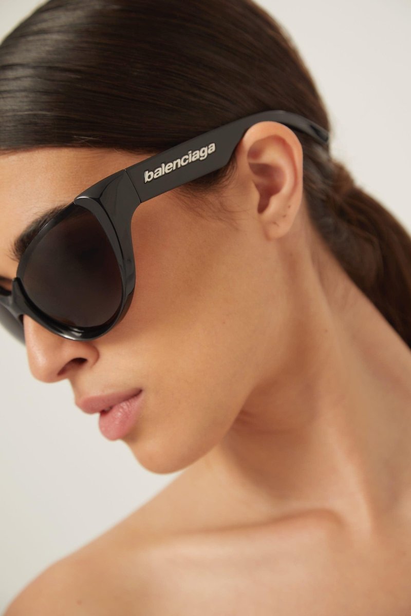 Black wrap around sunglasses – high relief metallic logo is prominently stamped on the middle of – LUX VERSE Luxury Designer Fashion Outlet