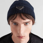 Wool and cashmere beanie – the iconic enameled metal triangle logo stands out on a leather triangle patch – LUX VERSE Luxury Designer Fashion Outlet