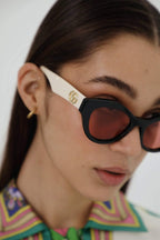 Cat eye black and cream sunglasses – pared-back simplicity characterizes the essential shapes, lines and colours of this – LUX VERSE Luxury Designer Fashion Outlet