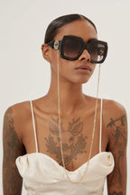 Oversized femenine black sunglasses with integrated GG logo – a new interpretation of Chain iconic concept to see with new eyes: – LUX VERSE Luxury Designer Fashion Outlet